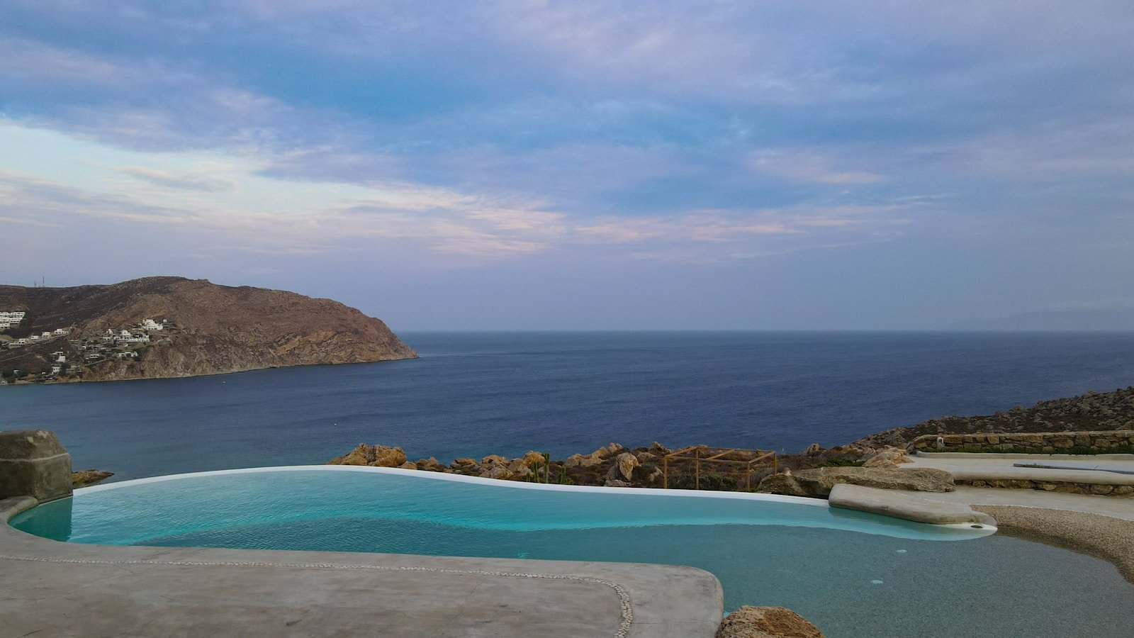 Whitewashed villa above the Aegean at dusk